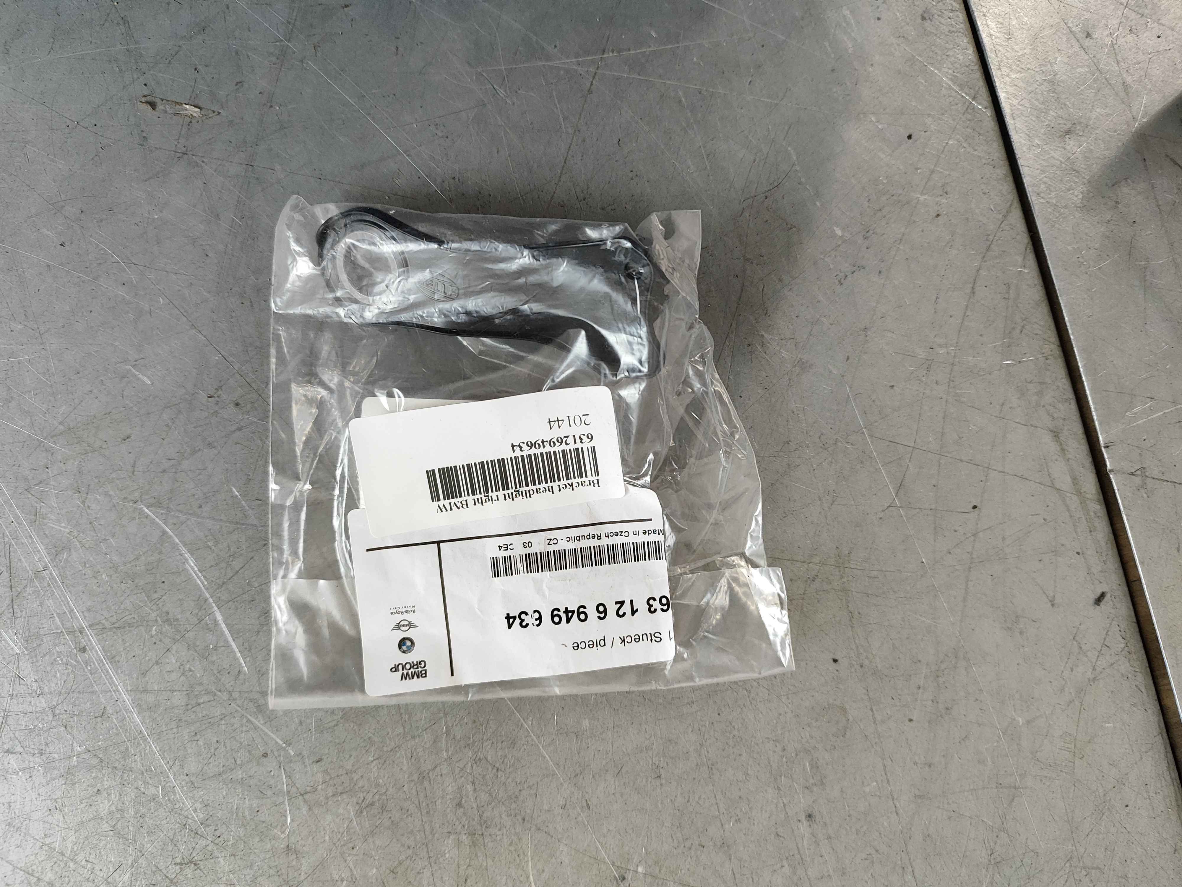 Bracket headlight right BMW